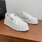 Unisex sneakers, white textured low-top design, lace-up with logo tongue tabs