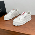 Unisex Prada sneakers, white textured uppers, lace-up, red/black tongue logos