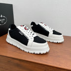 Prada unisex sneakers, black-and-white colorblocked leather panels, lace-up, treaded sole