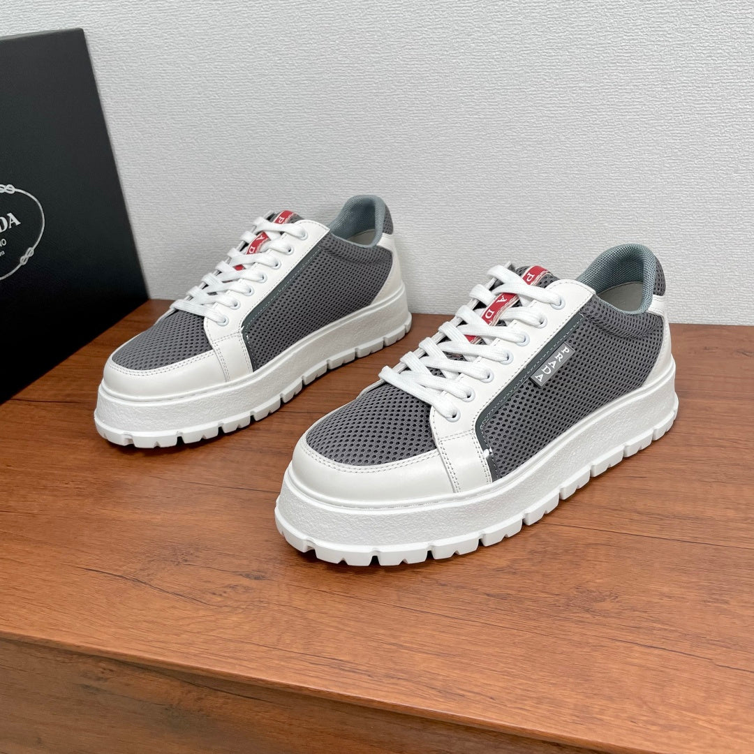 Prada unisex sneakers with white leather toe and gray perforated mesh, red logo tab
