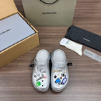 Balenciaga silver decorative clogs with croc-style vents and charm accents