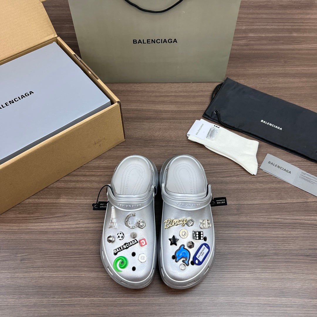 Balenciaga silver decorative clogs with croc-style vents and charm accents