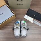 Silver slip-on clogs with vented toe and colorful charm patches