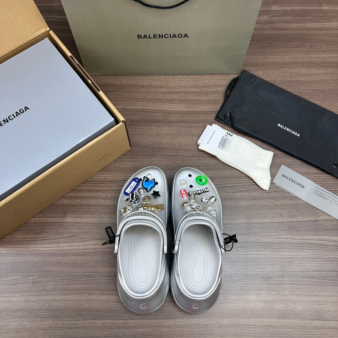 Silver slip-on clogs with vented toe and colorful charm patches