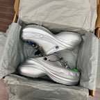 Silver clogs in open box, shown with charm accents and cushioned footbeds