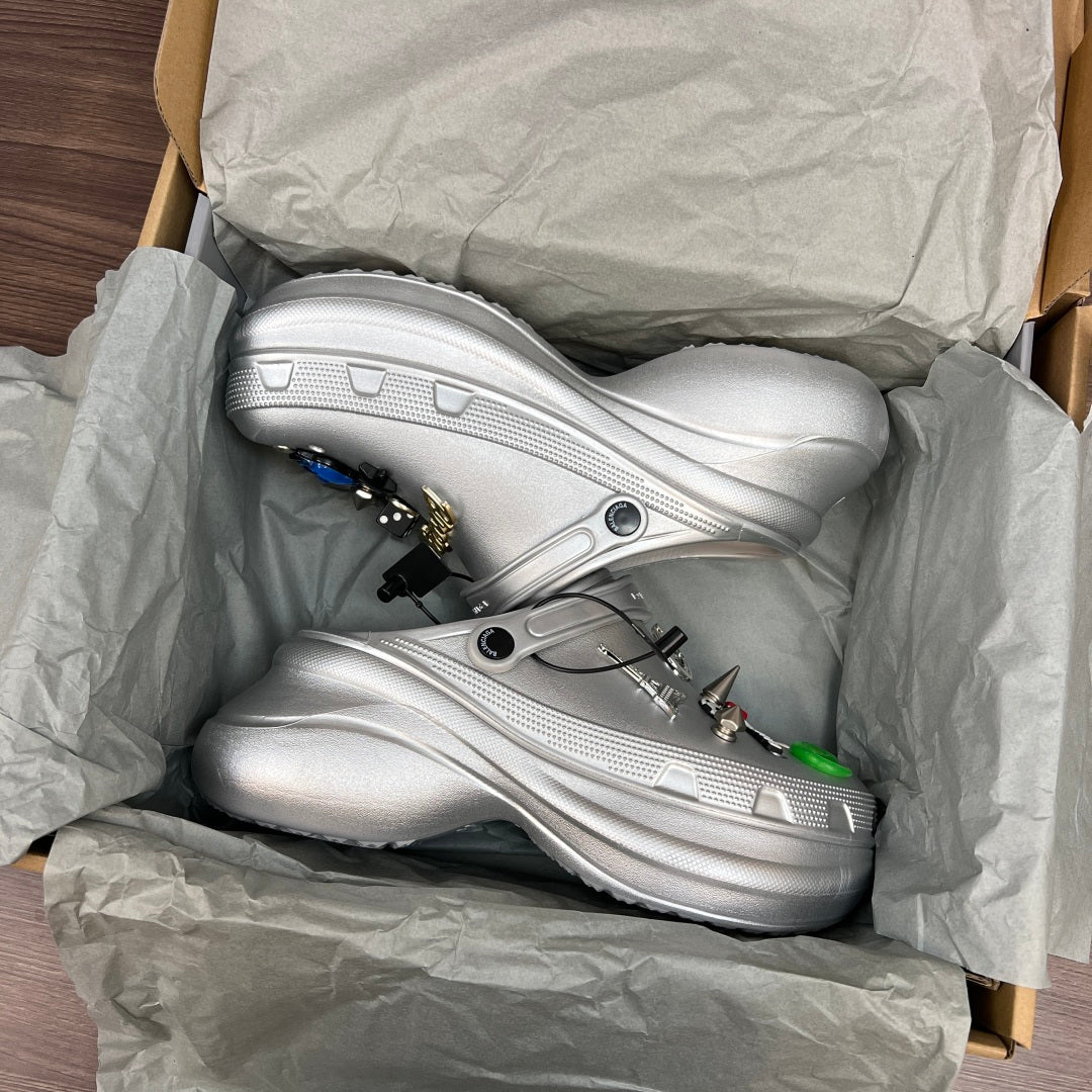 Silver clogs in open box, shown with charm accents and cushioned footbeds