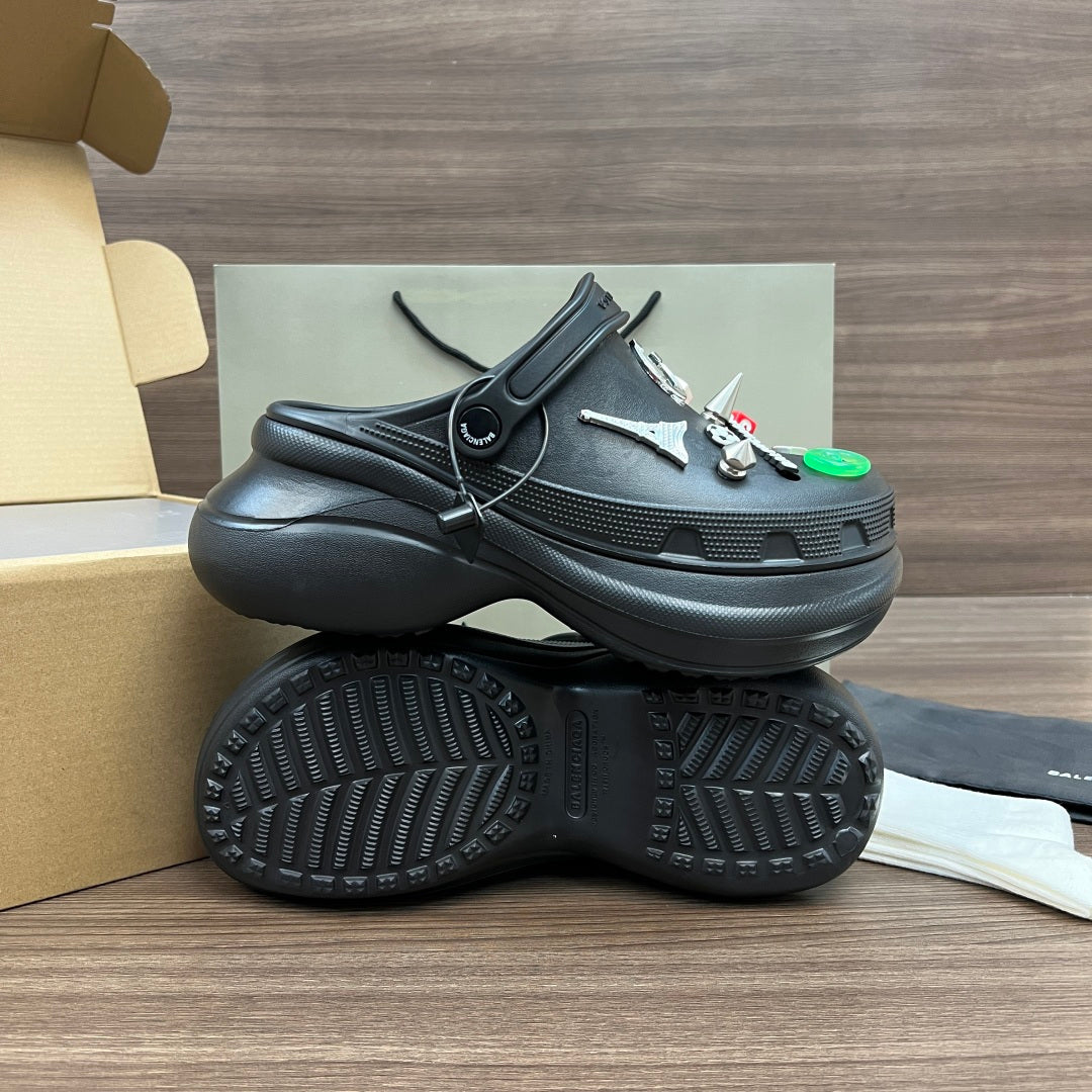 Black Balenciaga sandals with lace strap and textured outsole, side and bottom view