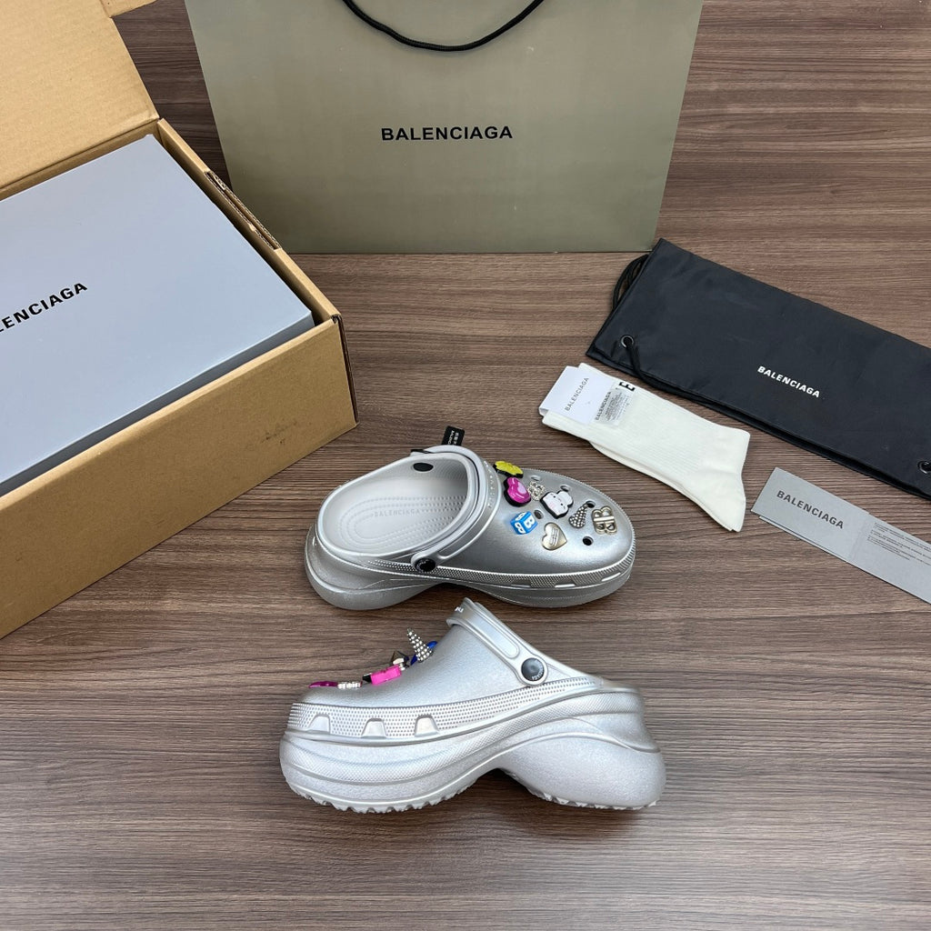 Balenciaga silver platform clogs, side view, with multicolor charm decorations