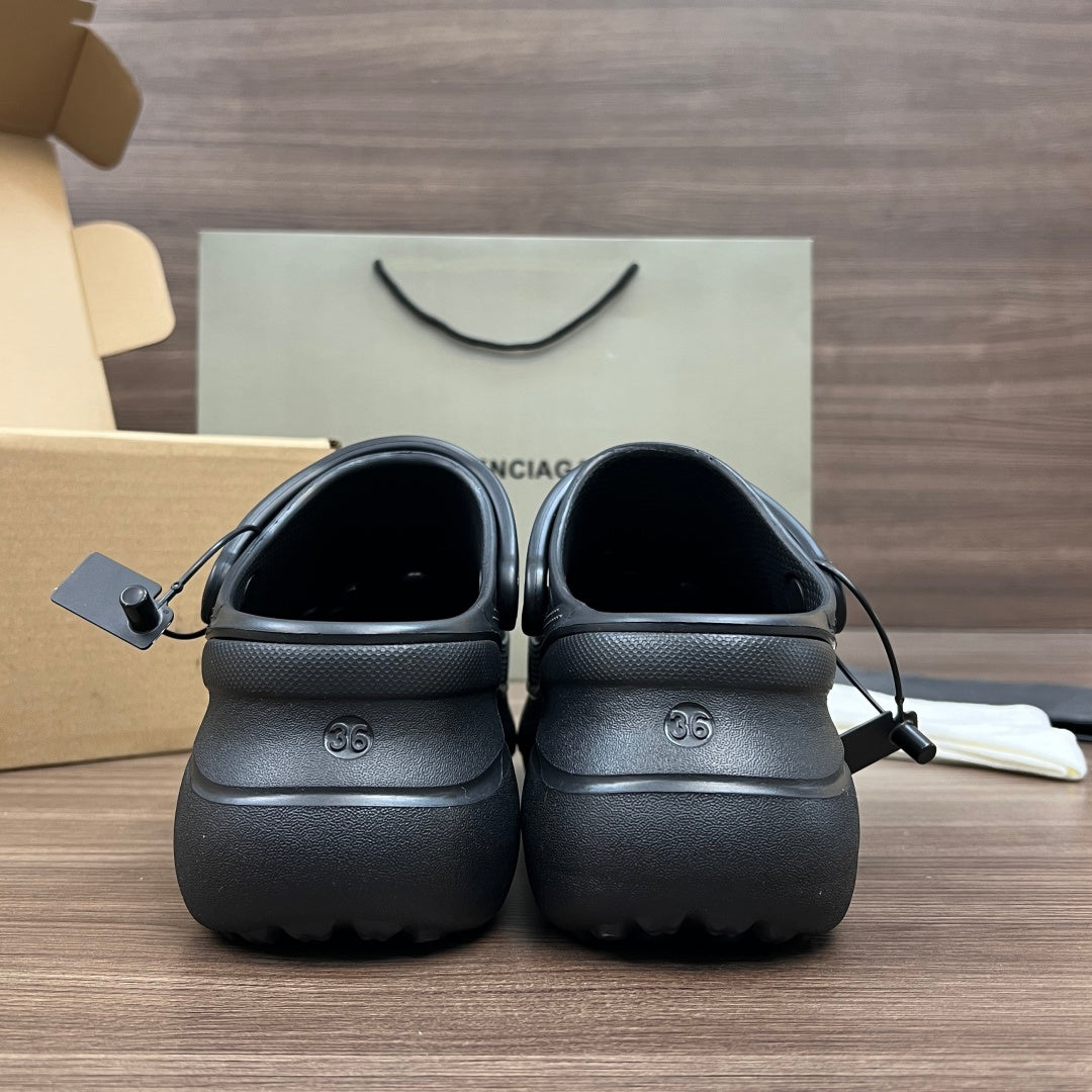 Pair of black Balenciaga sandal clogs shown from the back with embossed logo