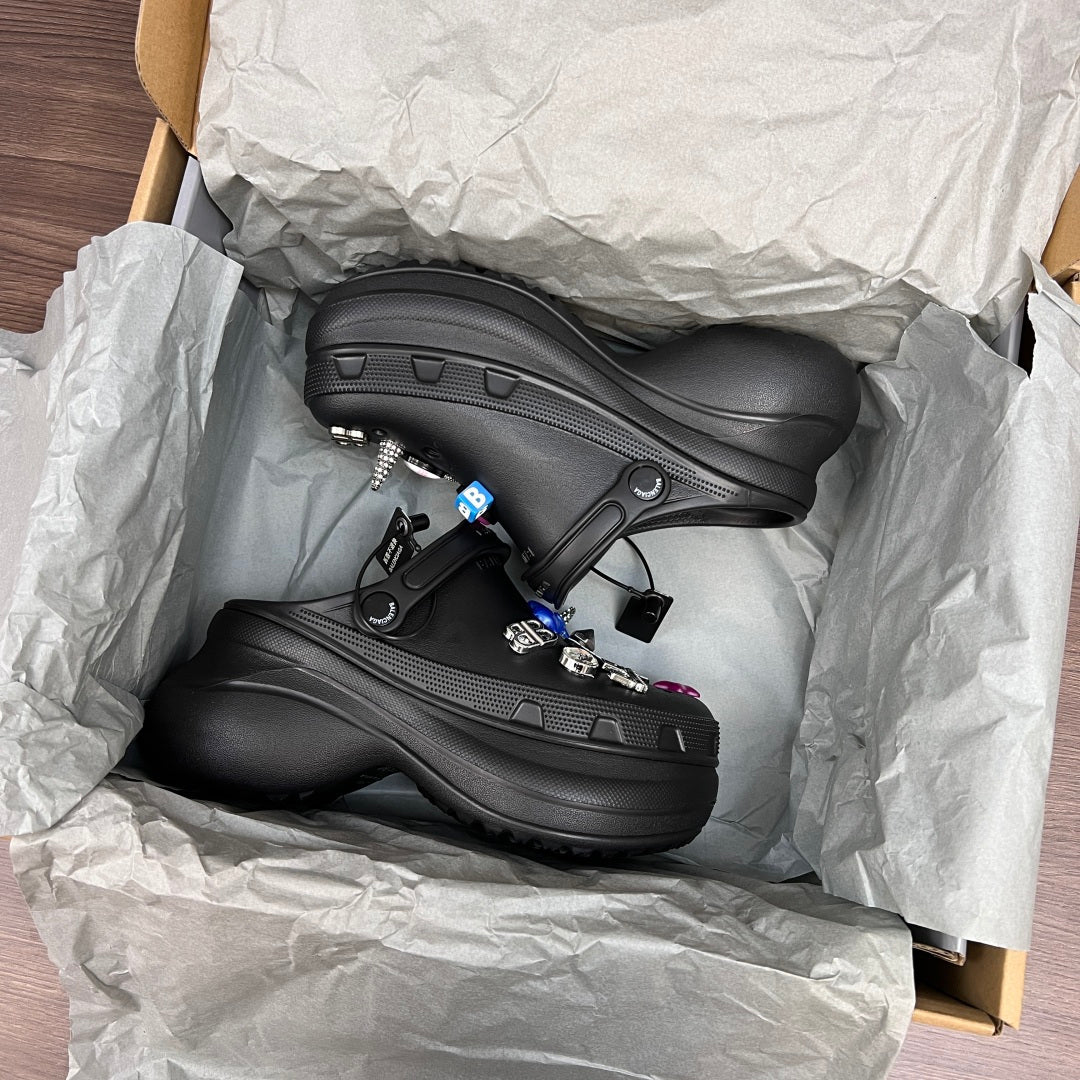 Black Balenciaga sandal clogs in open box with visible mesh texture and strap details