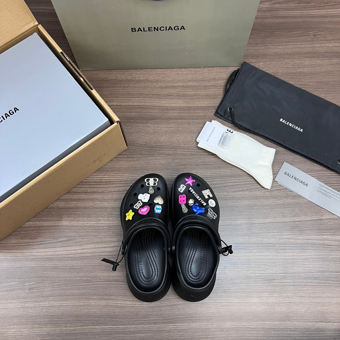 Black Balenciaga sandal clogs with colorful charm accents on the top panels