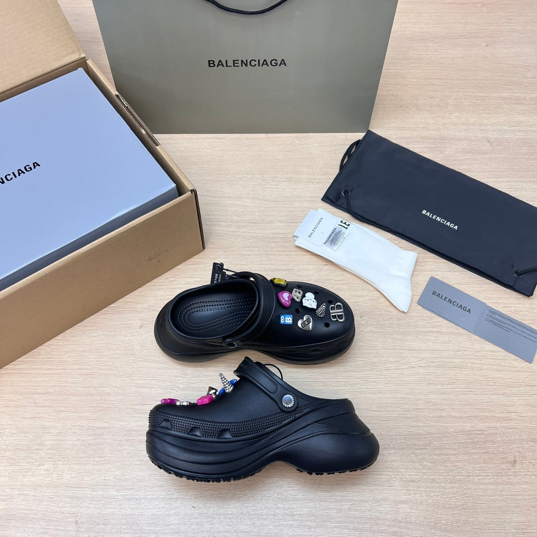 Black Balenciaga slide sandals with colorful charm accents and thick sole