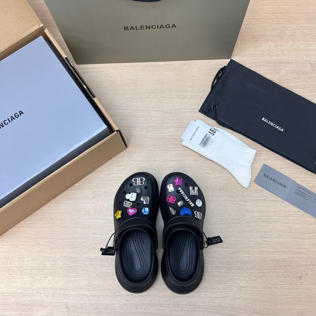 Black Balenciaga slide sandals, top view with colorful charm decorations