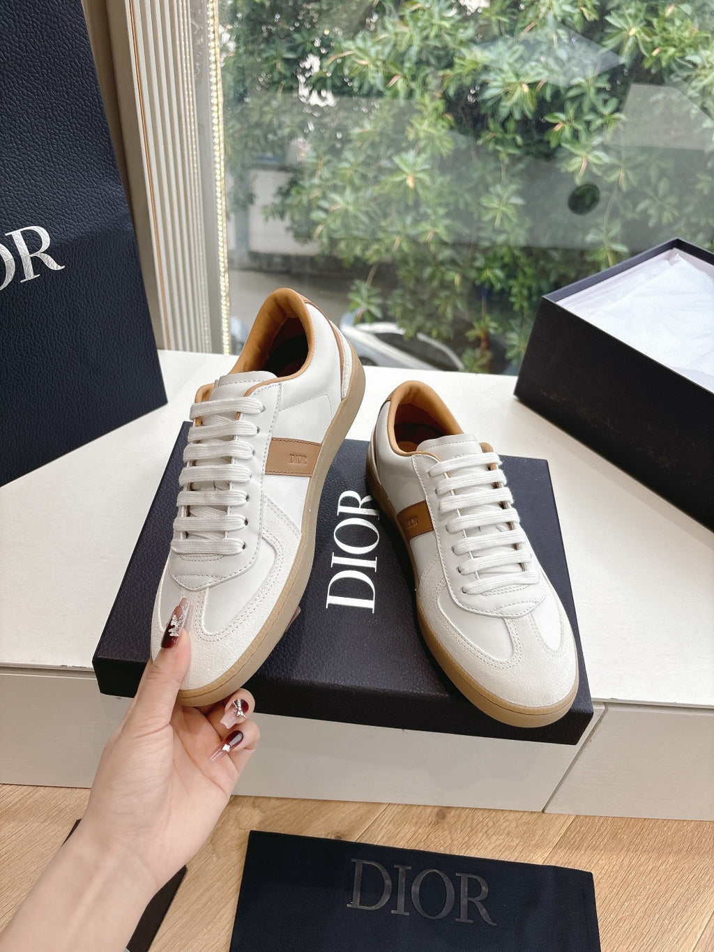 White and tan unisex sneakers, lace-up with tan trim along the side