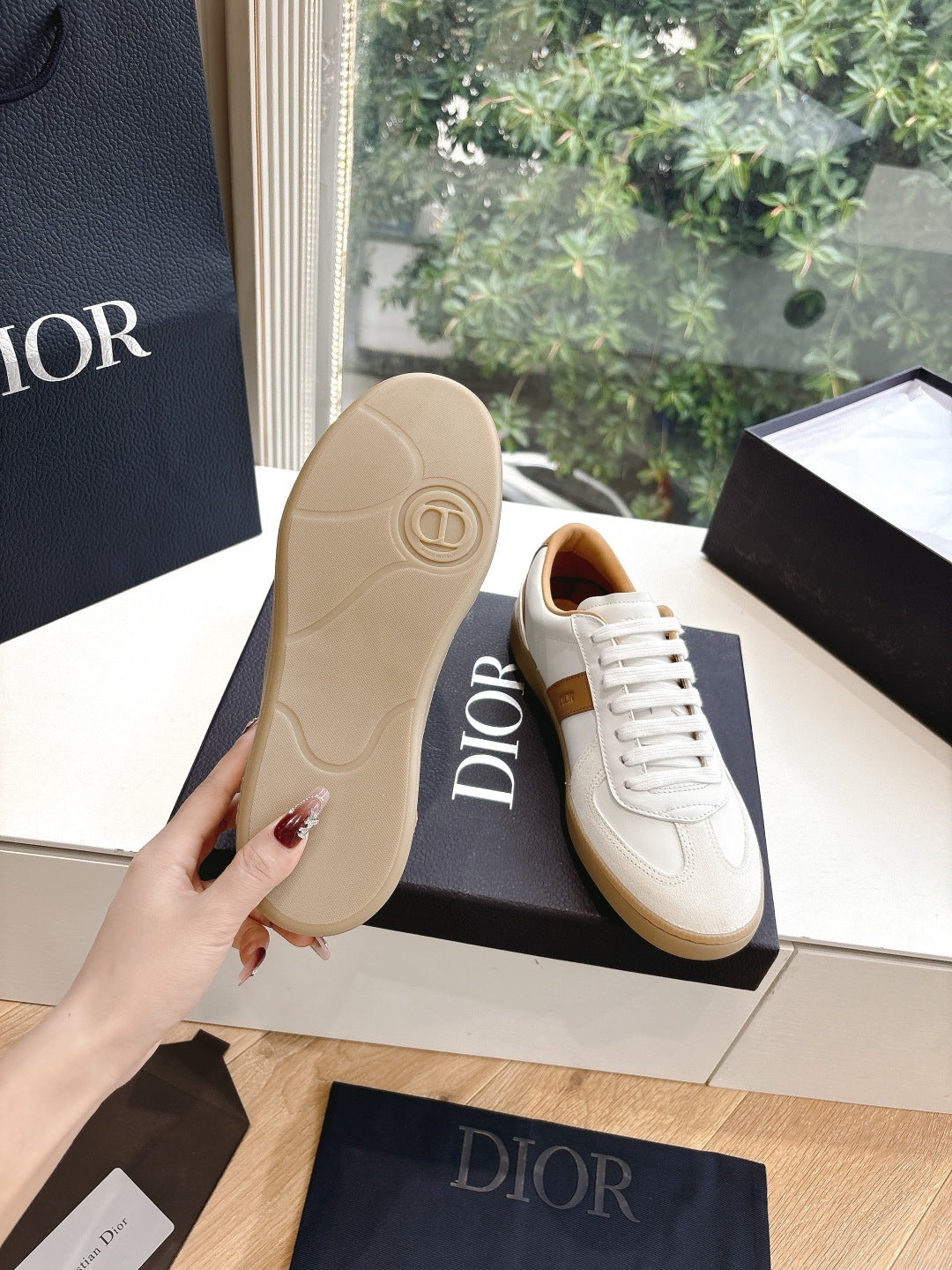 White and tan unisex sneakers with gum sole, shown from heel side