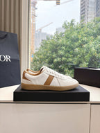 White and tan unisex sneakers, side profile on display box