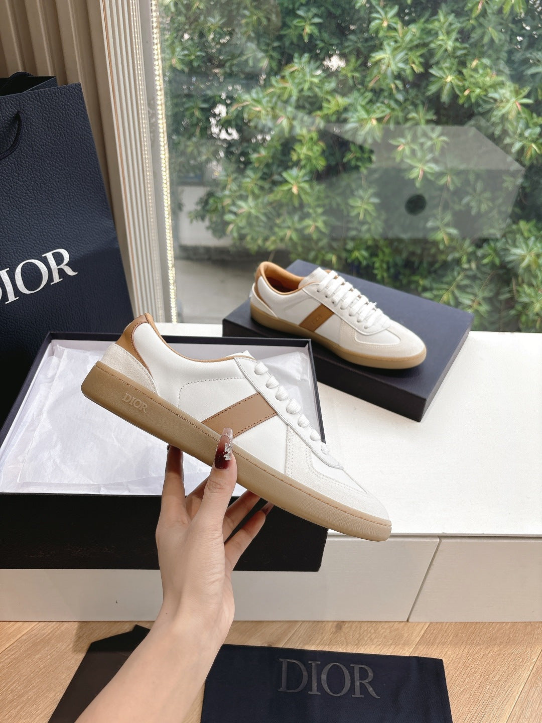 White and tan unisex sneakers with tan side panel and lace-up design
