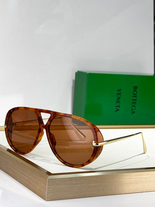 Brown tortoise sunglasses with amber lenses and thin gold-tone metal arms