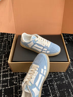 Light blue low-top sneakers with white laces and a textured rubber sole