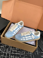 Light blue low-top sneakers with white laces and white logo side stripe details
