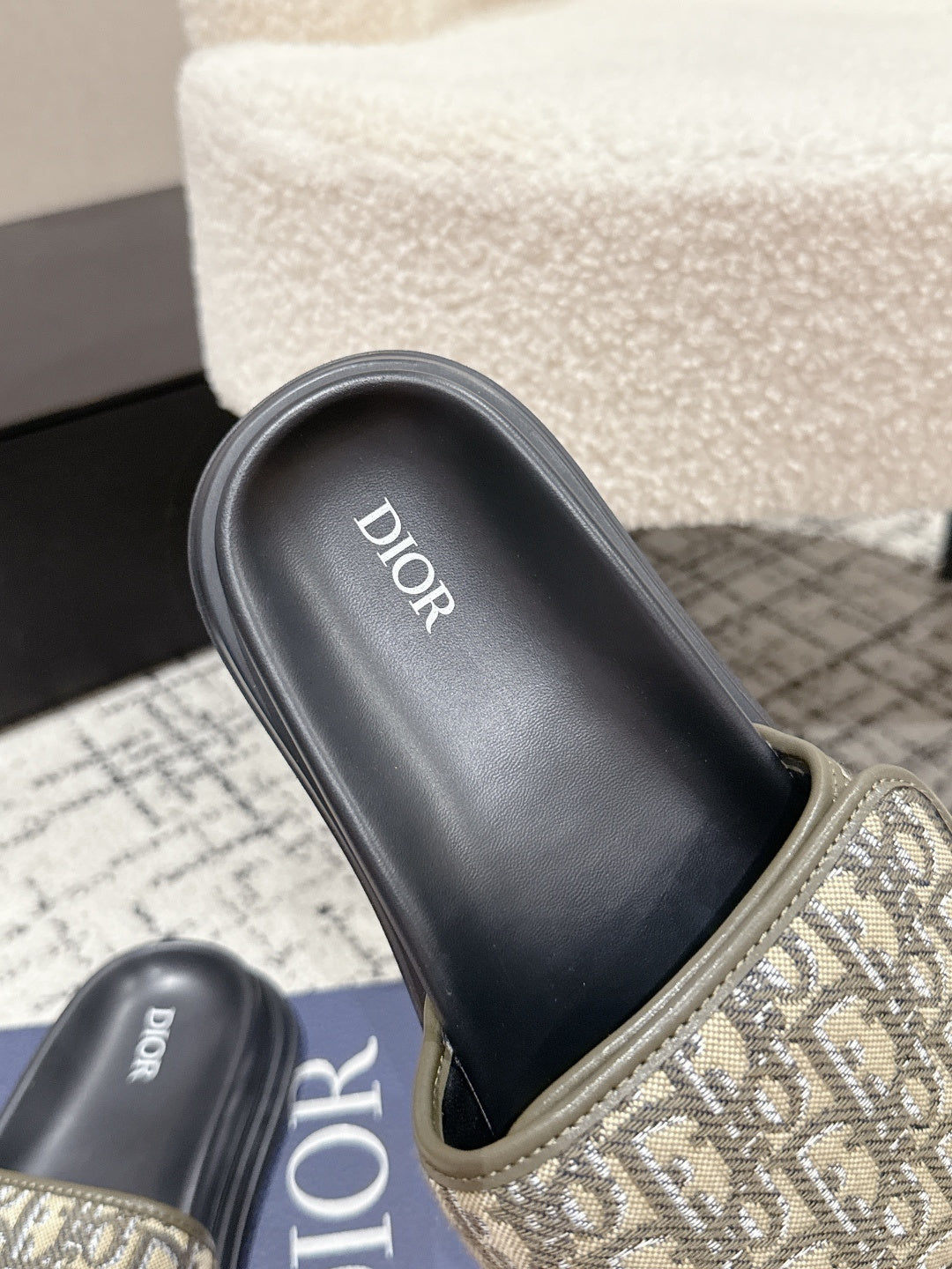 Dior slide sandals with beige Oblique strap, black footbed, and DIOR branding
