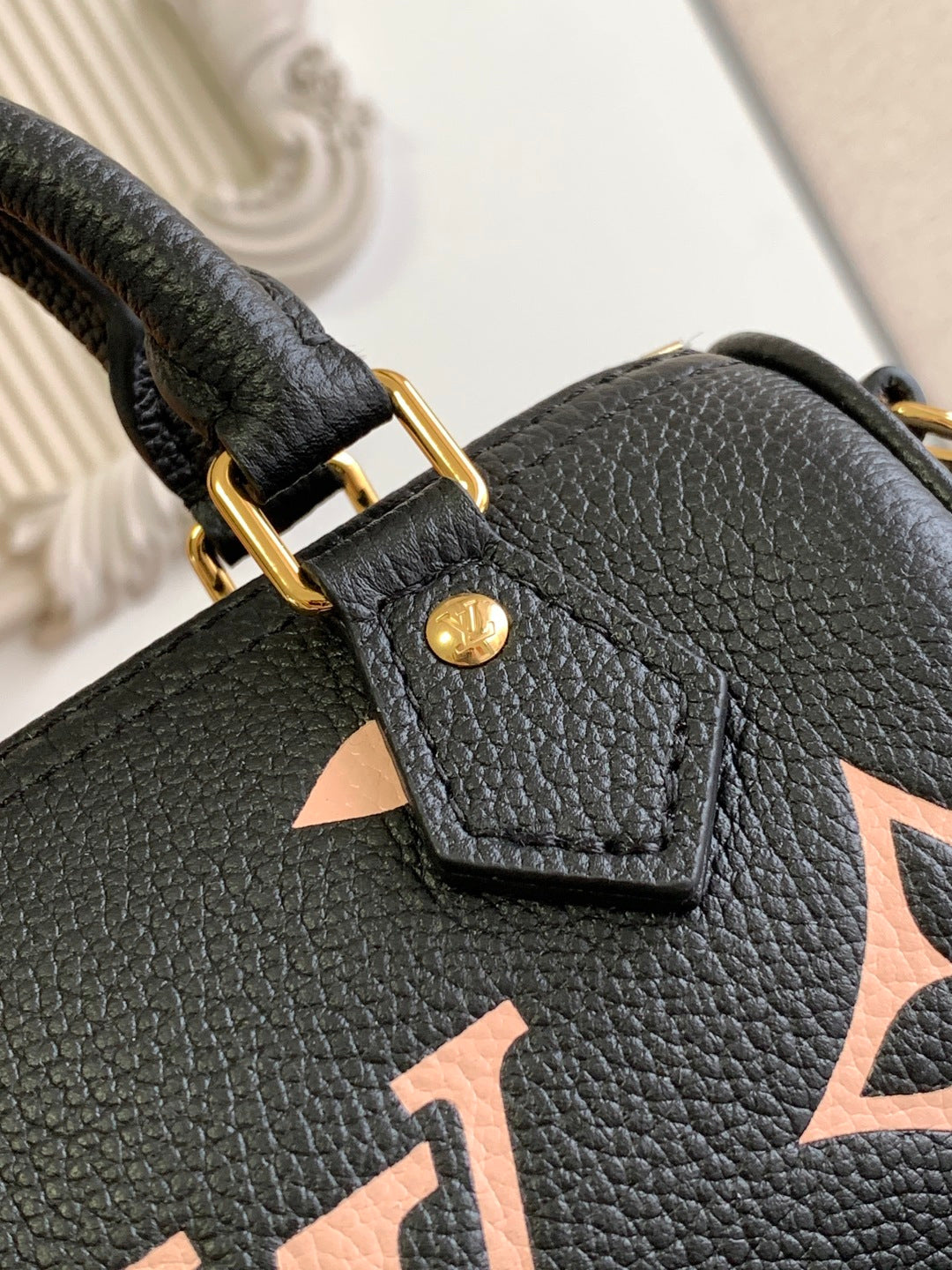 Louis Vuitton black textured leather bag with gold D-ring and star-shaped charm