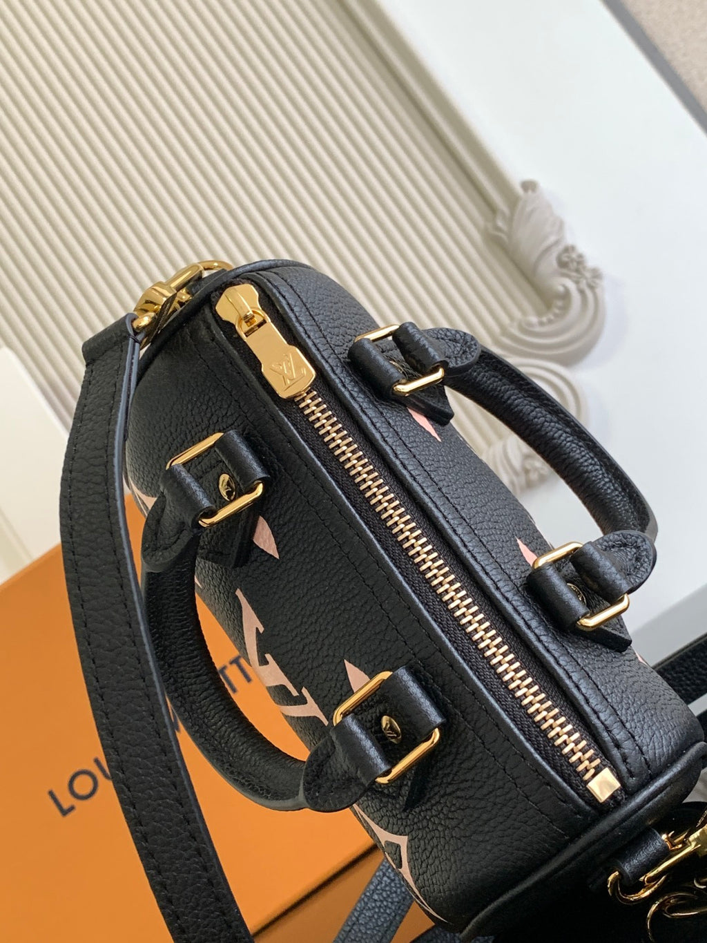 Louis Vuitton black monogram zip-top bag with gold zipper and front straps