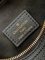Louis Vuitton Paris France leather label inside black bag with gold text