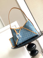 Louis Vuitton monogram tote bag with blue canvas, tan handles, and shoulder strap