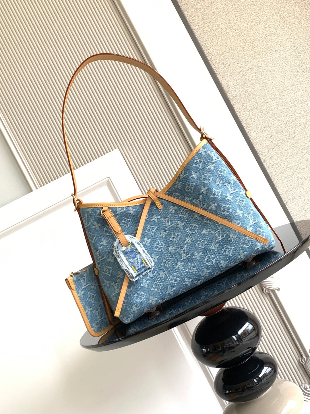 Louis Vuitton monogram tote bag with blue canvas, tan handles, and shoulder strap