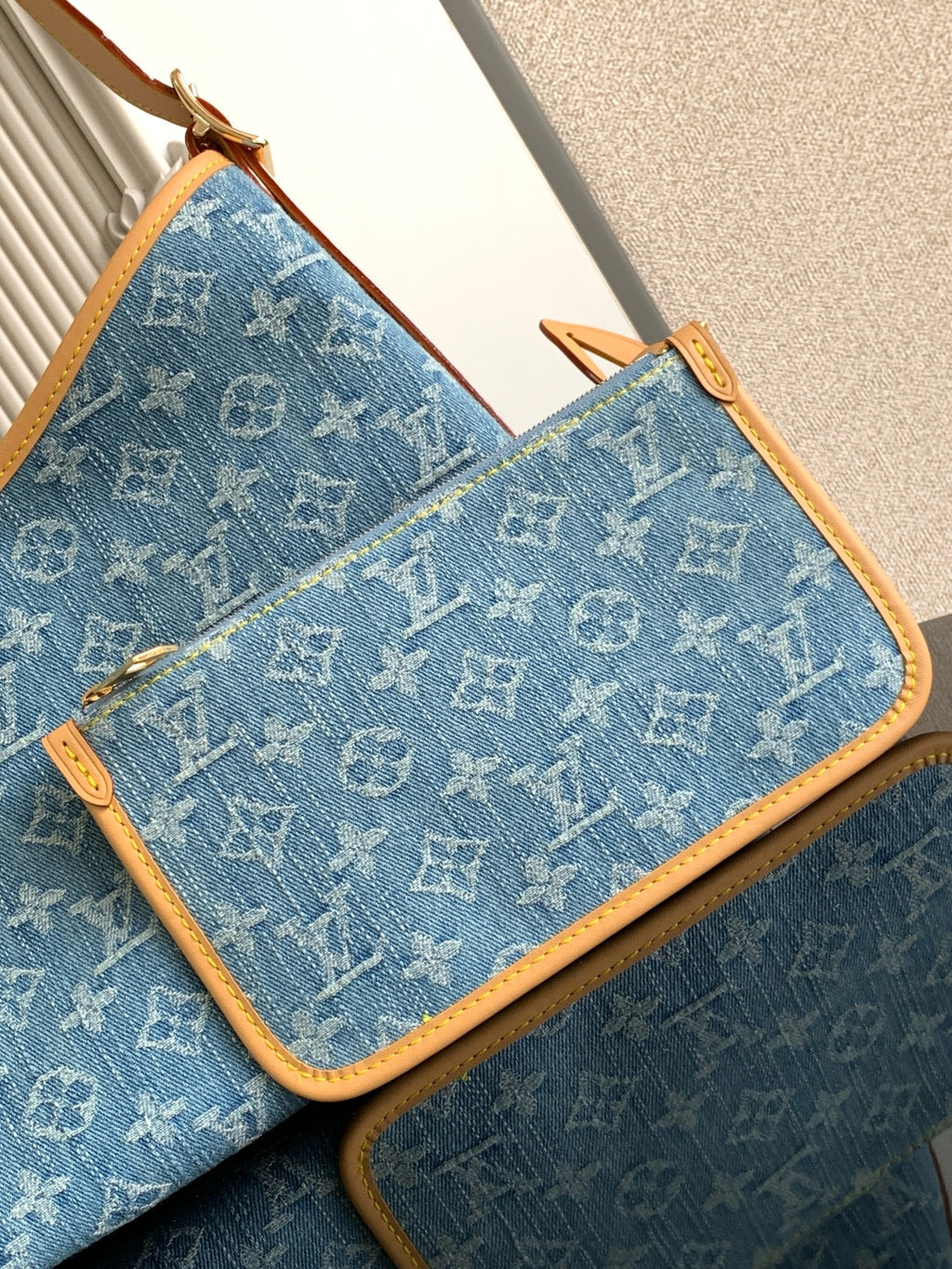 Louis Vuitton monogram zip pouch in blue canvas with tan zipper trim and edges
