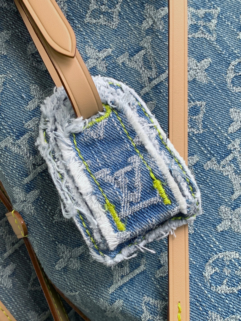 Louis Vuitton monogram crossbody pouch with blue canvas, fringe trim, and tan strap