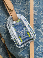 Louis Vuitton monogram crossbody pouch with blue canvas, fringe trim, and tan strap
