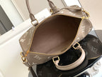 Louis Vuitton bag top view: taupe exterior with monogram pattern and gold zipper