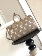 Louis Vuitton bag in taupe with monogram pattern, top handles and shoulder strap