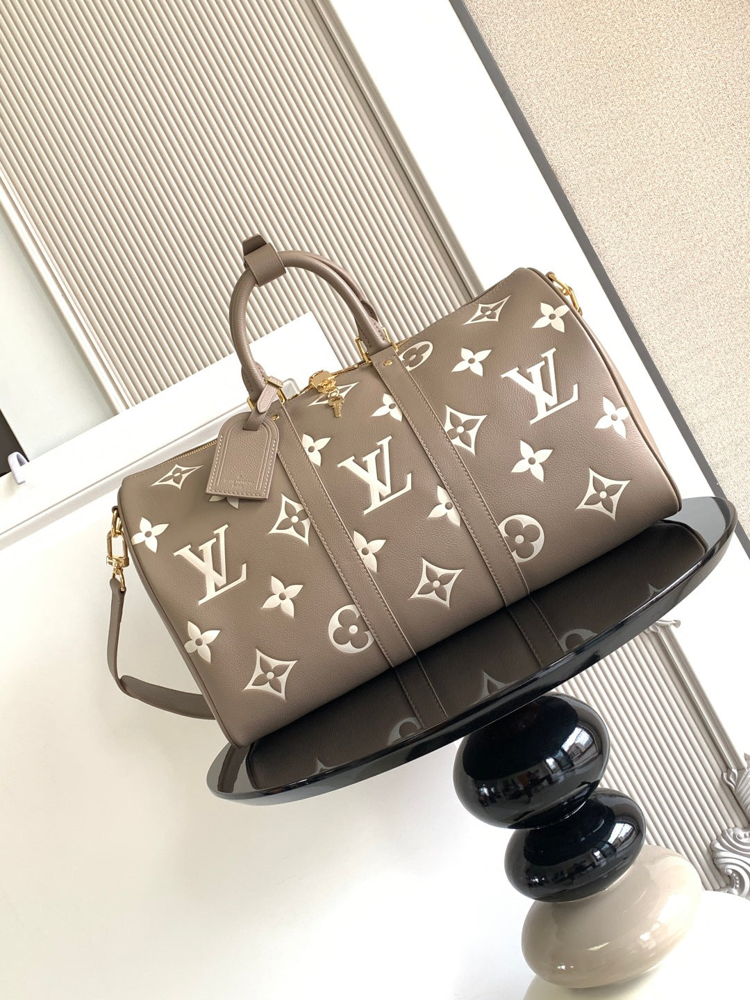 Louis Vuitton bag in taupe with monogram pattern, top handles and shoulder strap