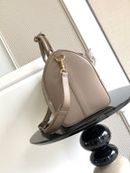 Louis Vuitton crossbody bag in taupe, rounded shape, gold hardware and side strap