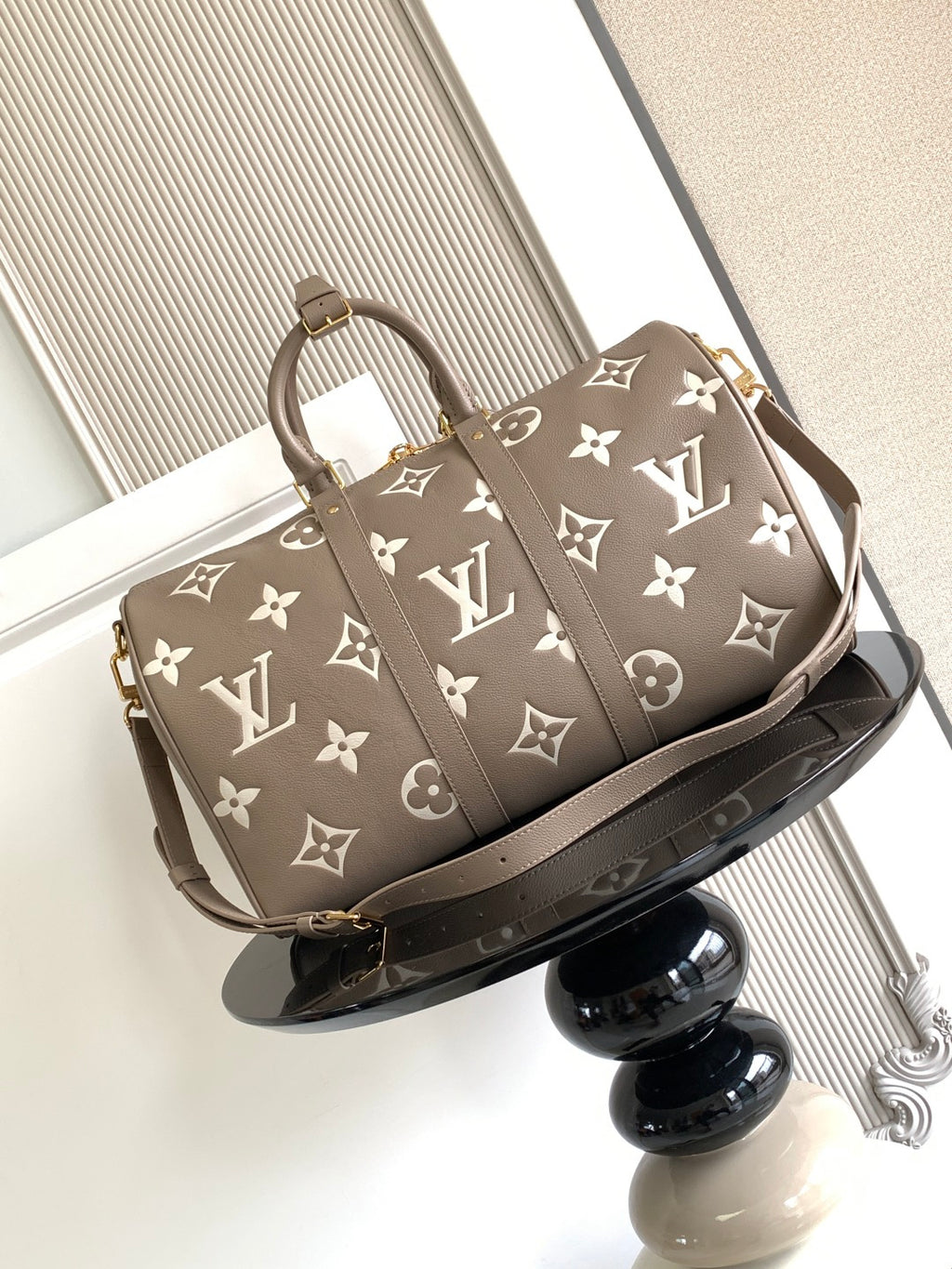 Louis Vuitton bag in taupe with white monogram print, top handles and crossbody strap