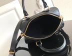 Louis Vuitton bag open view with black interior and gold-tone zipper along top edge