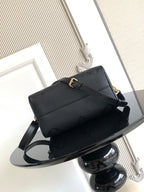 Louis Vuitton structured handbag in dark color with top handle and crossbody strap
