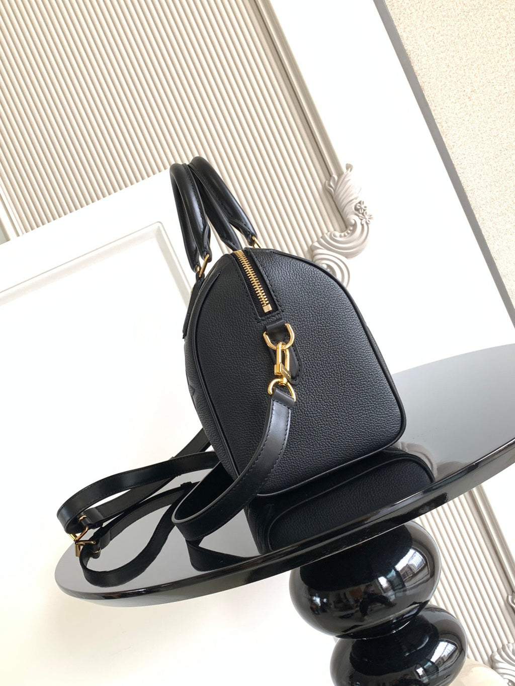 Louis Vuitton monogram handbag with gold-tone hardware and curved top handle