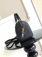 Louis Vuitton monogram handbag with gold-tone hardware and curved top handle