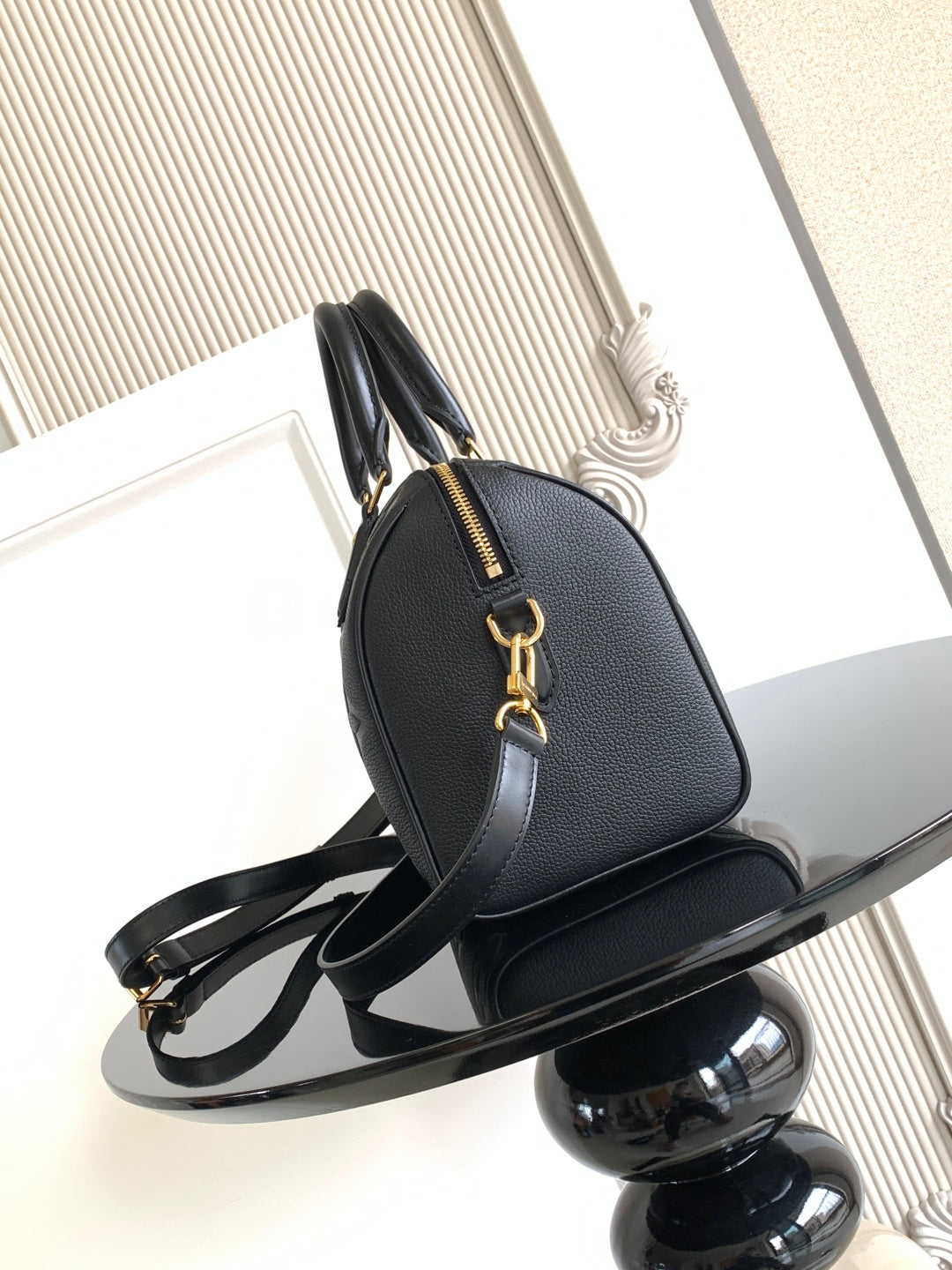 Louis Vuitton monogram handbag with gold-tone hardware and curved top handle