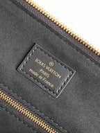Louis Vuitton made in France label on dark leather with gold zipper stitching