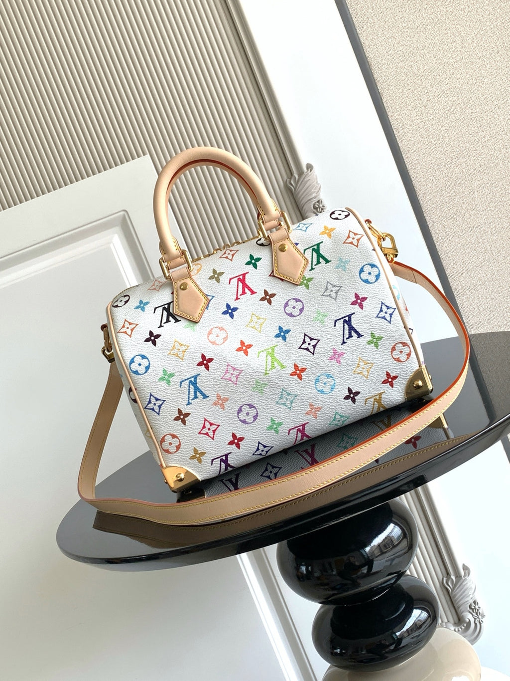 Louis Vuitton monogram handbag with multicolor allover pattern and tan strap