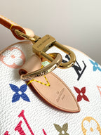Louis Vuitton monogram handbag close-up of gold ring and tan leather strap tab