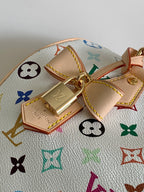 Louis Vuitton monogram handbag close-up of tan tab charm and gold clasp
