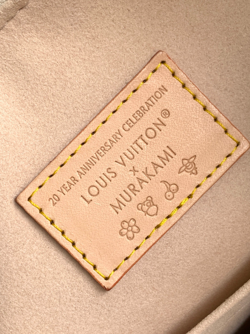 Louis Vuitton handbag leather interior label with embossed text and stitching