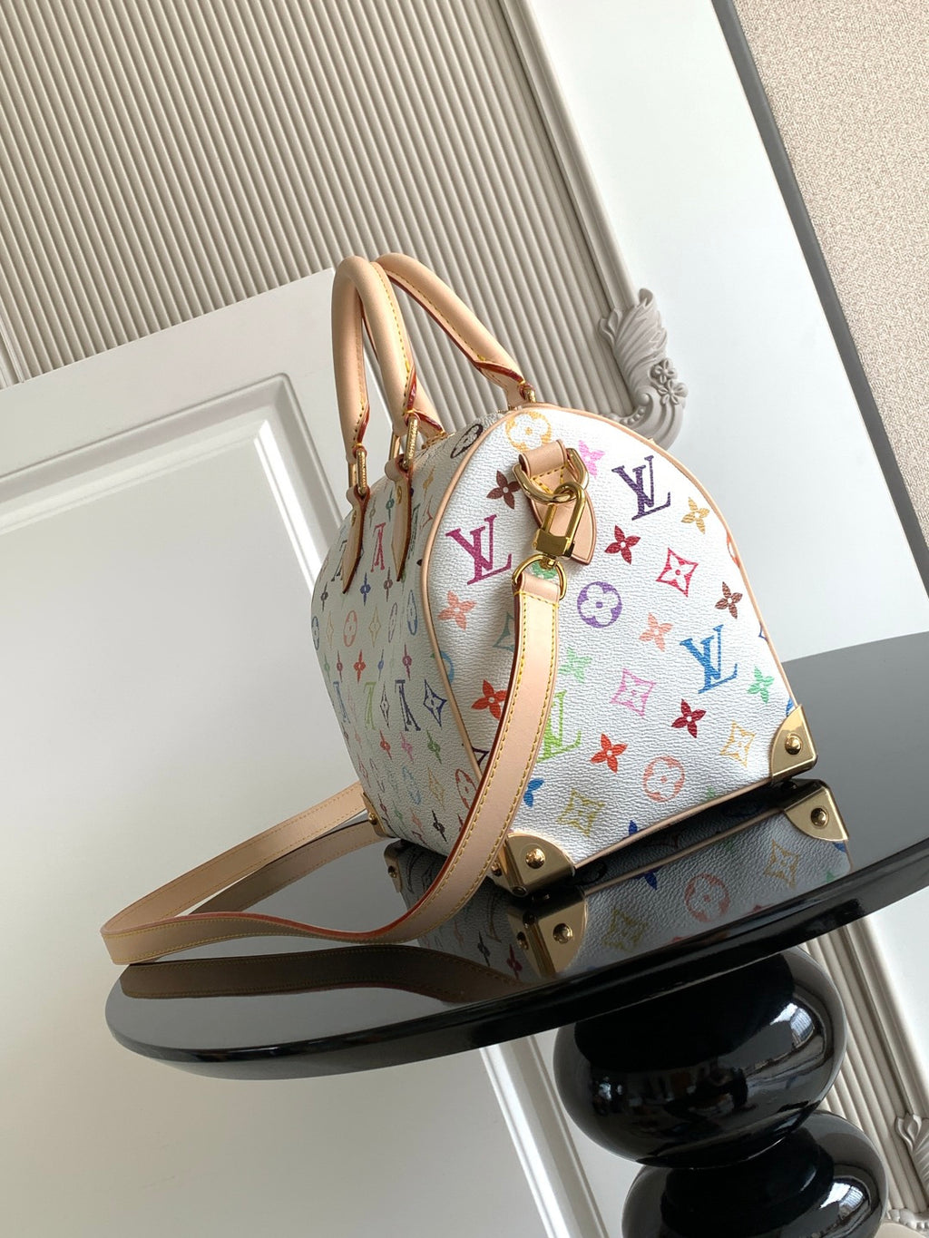 Louis Vuitton monogram handbag in multicolor print with tan leather handles
