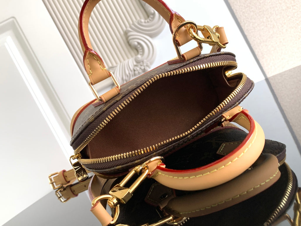 Louis Vuitton monogram bag open top showing interior and gold zipper pulls